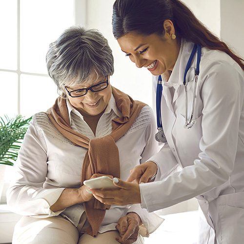 Caring,Doctor,Teaches,Female,Patient,To,Use,Mobile,Healthcare,App. EMPOWERING YOUR HEALTH JOURNEY