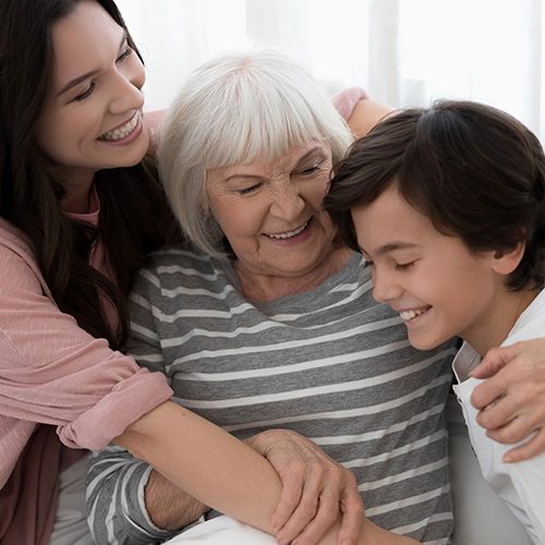 Smiling,Pleasant,Joyous,Senior,Gray-haired,Caucasian,Lady,Hugging,Fondly,Her
